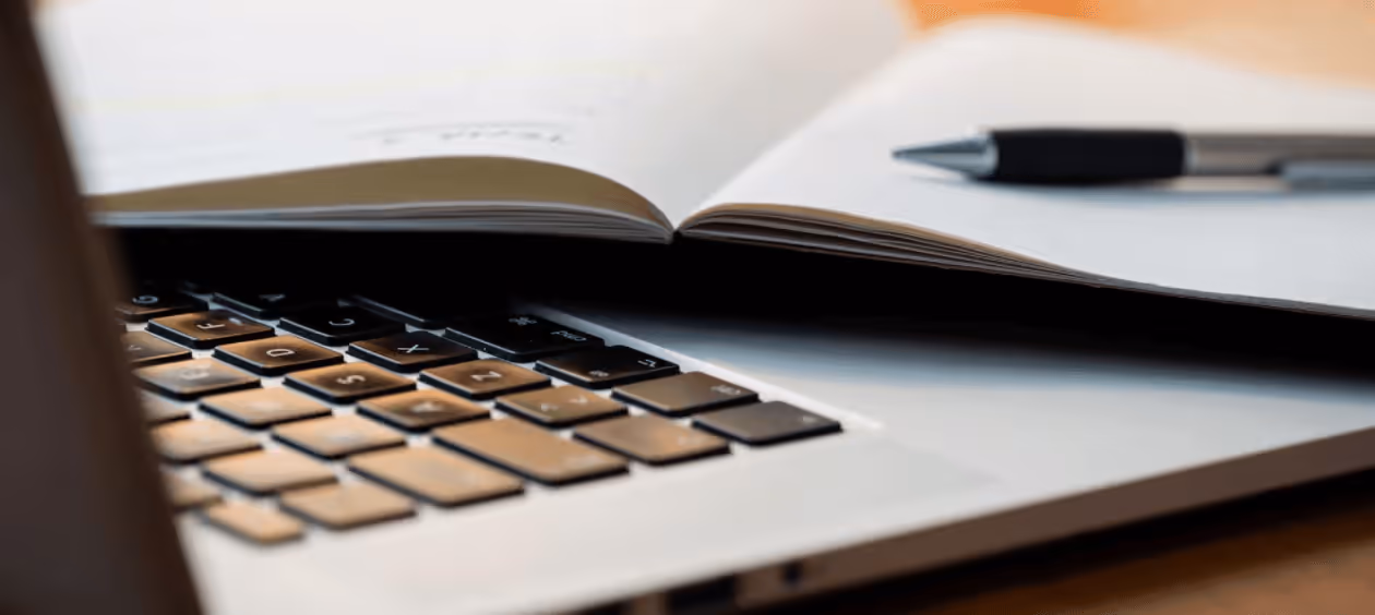 A client diligently reviewing a task list on their MacBook to complete their mortgage application, guided by a Calgary mortgage broker